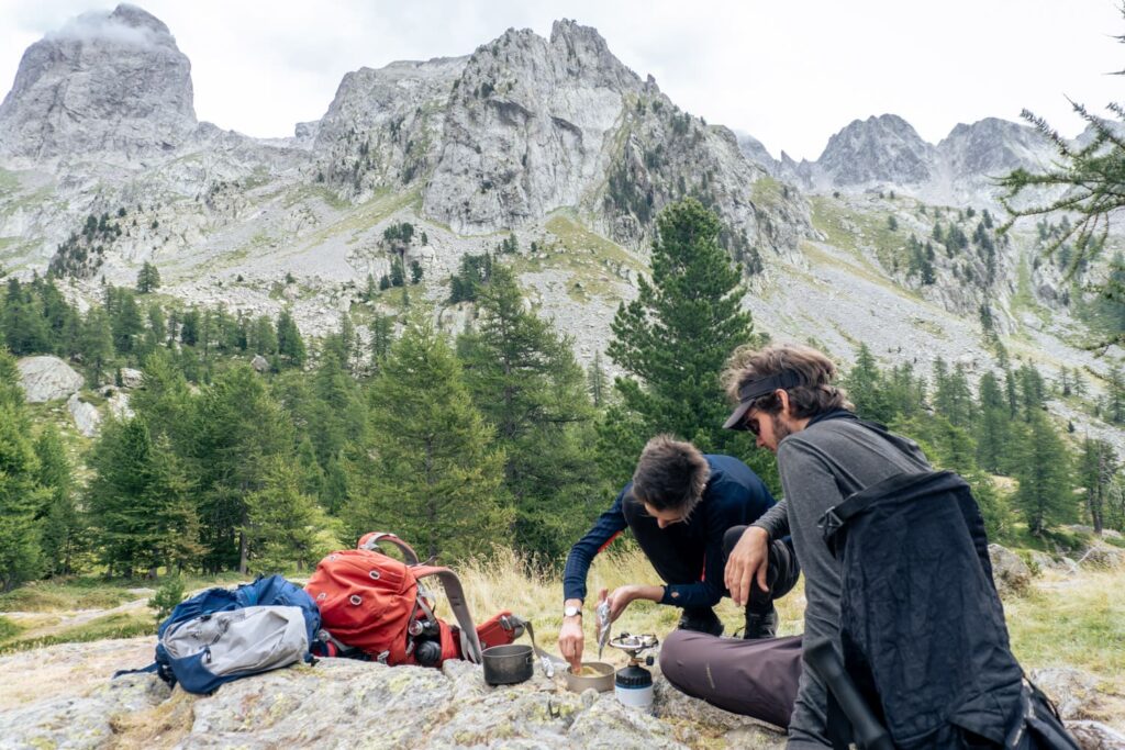 Zwei Wanderer am Kochen vor Bergen - GR 52 Fotos